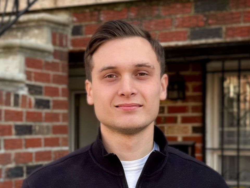 Vlad, owner and technician of Kashtak HVAC & Appliance Service, in front of a Brooklyn brownstone